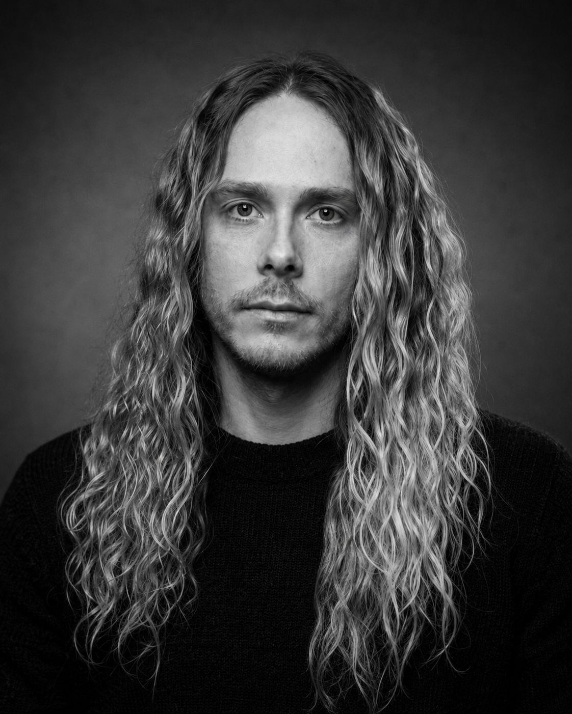 Black-and-white studio portrait of Drew V.